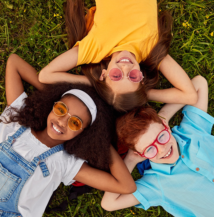 kids laying down in grass